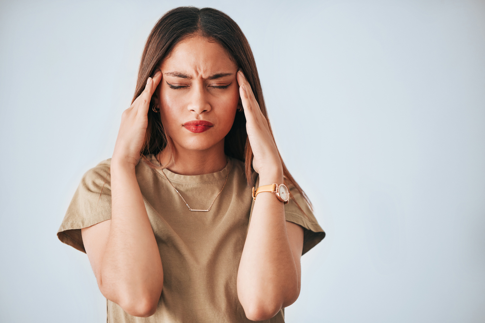 Headache, stress and woman in studio with anxiety, temple massage and pain on mockup background. Burnout, brain fog and girl suffering migraine, vertigo or dizzy, fatigue or frustrated by problem